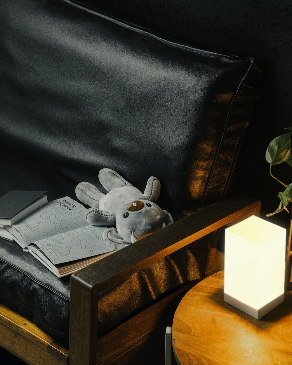 a stuffed animal sitting on top of a couch next to a table