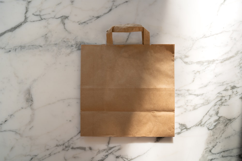 a brown paper bag sitting on top of a marble counter