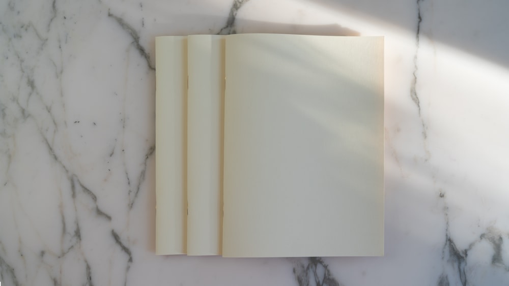 an open book sitting on top of a marble counter