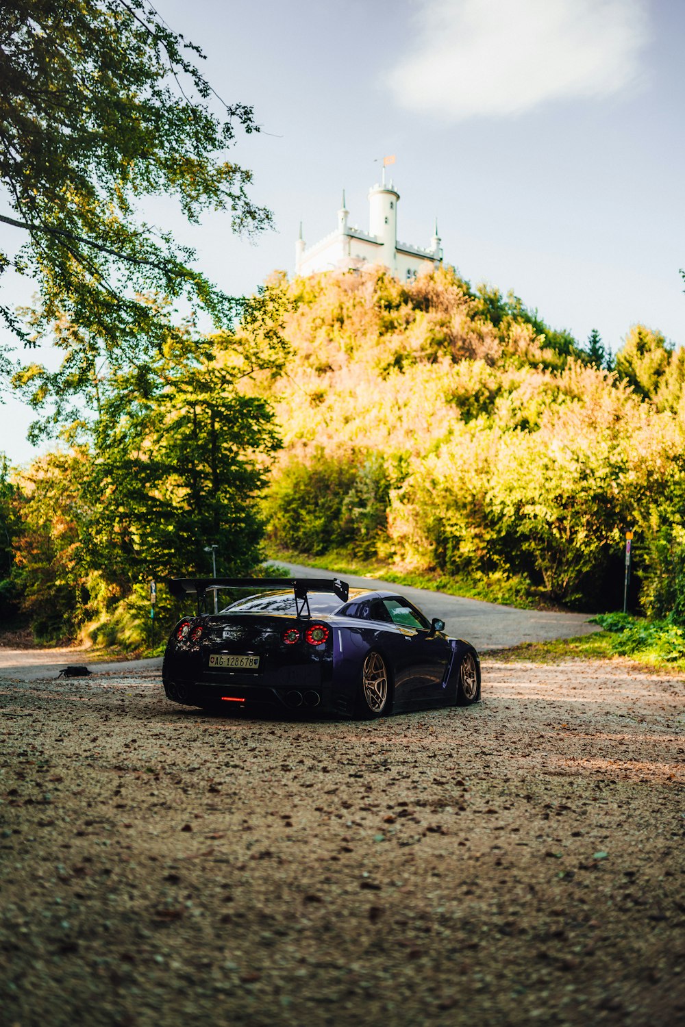 a black sports car parked on the side of a road