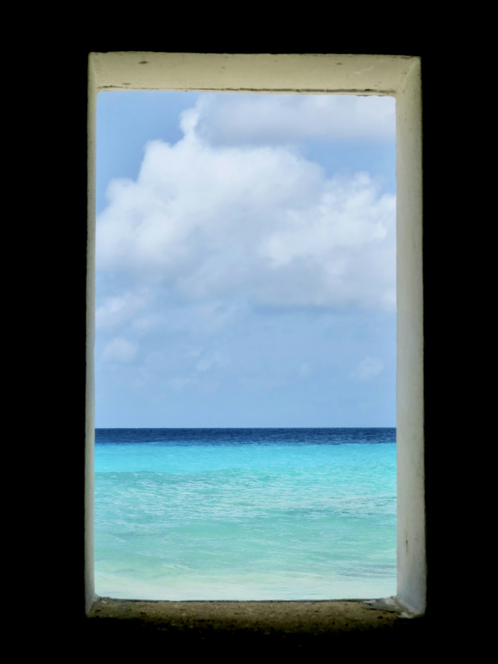 a view of the ocean through a window