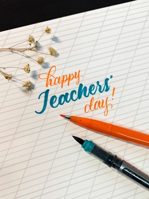 Teachers and students celebrating Teacher's Day with smiles and flowers