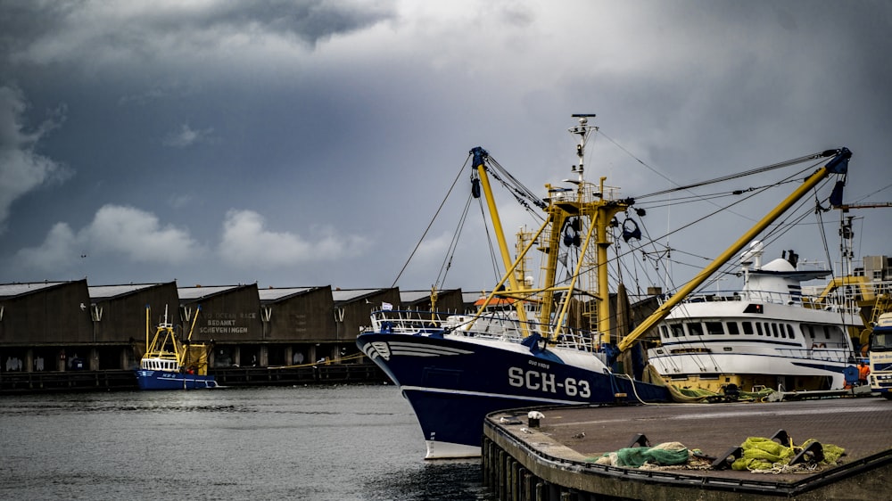 a boat docked in a harbor with other boats in the background