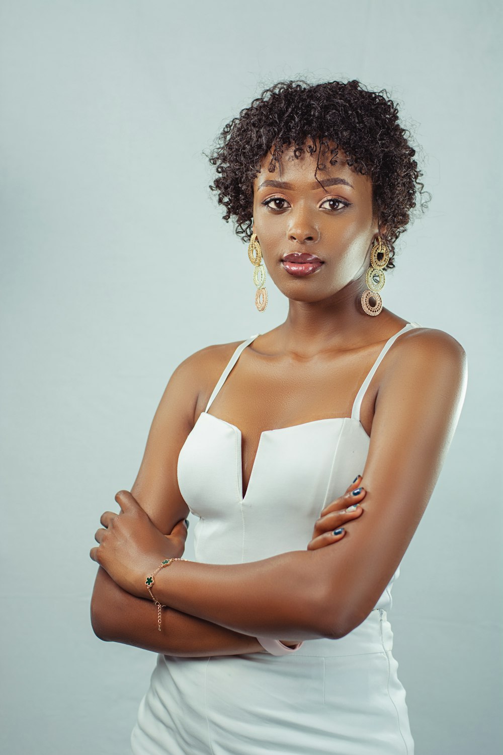 a woman in a white dress posing for a picture