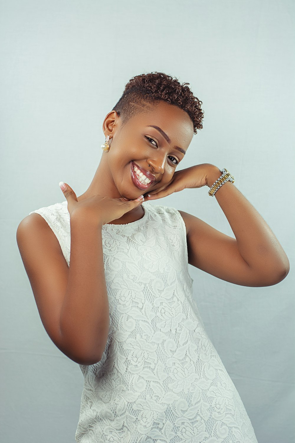 a woman in a white dress posing for a picture