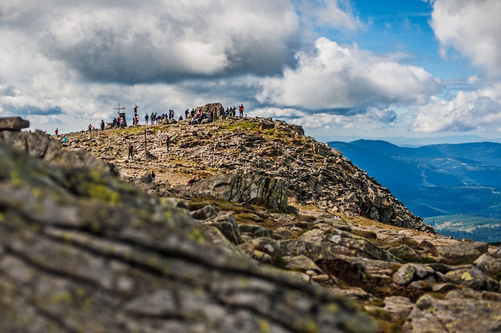 um grupo de pessoas em pé no topo de uma montanha