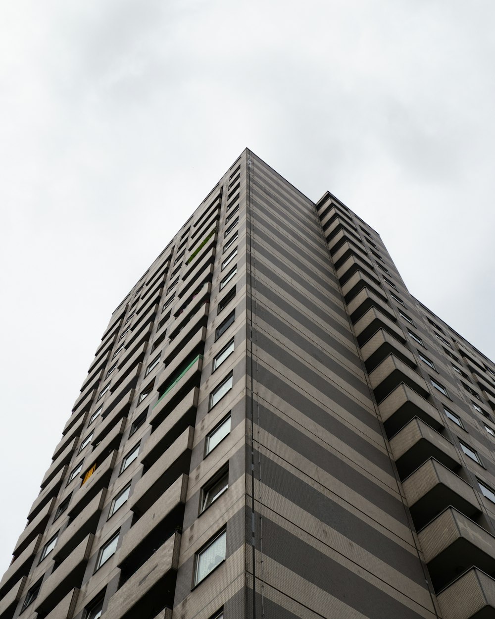 a tall building with lots of windows and a sky background
