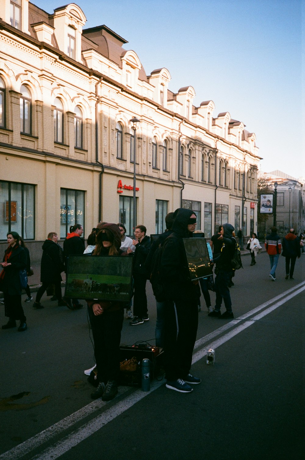 a group of people standing on the side of a road