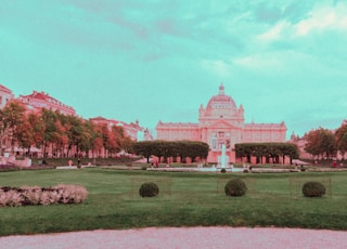 a large building with a fountain in front of it