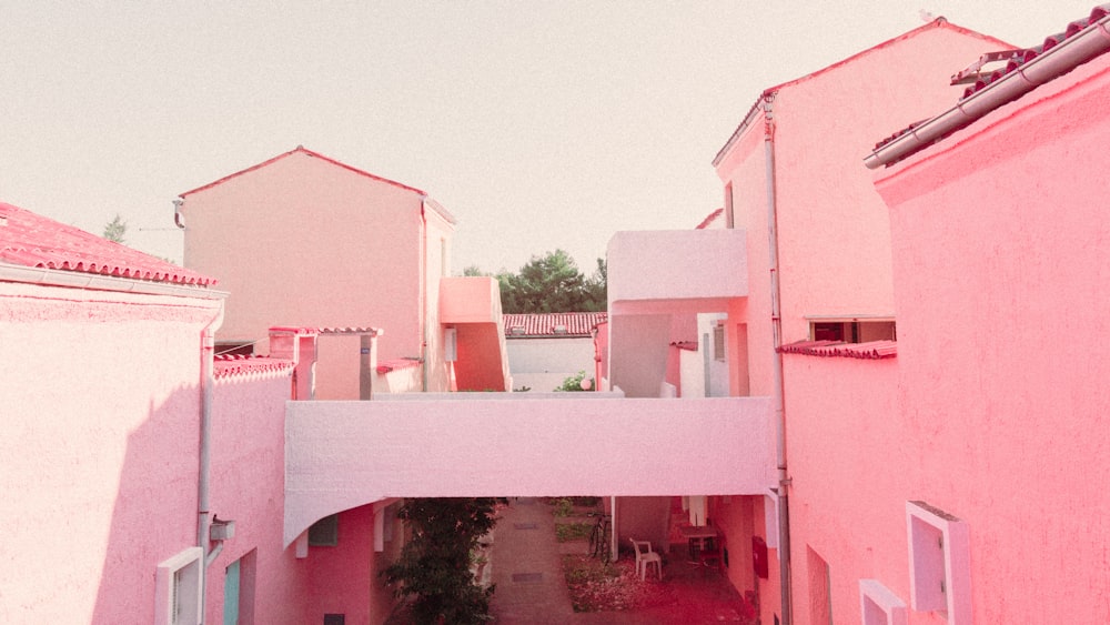 a view of a pink building from a balcony