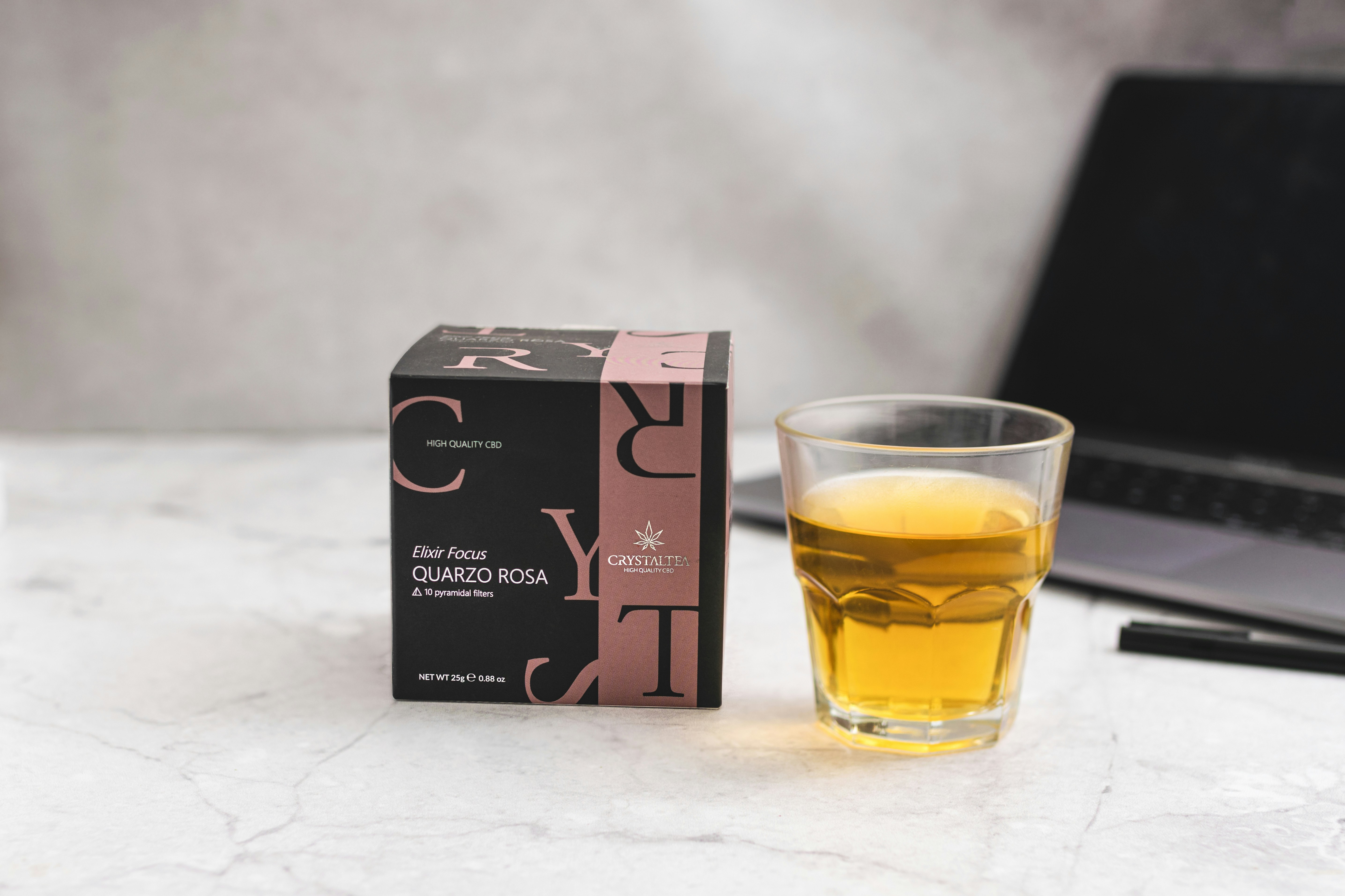 a glass of tea next to a box of tea