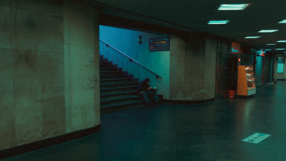 a person sitting on a bench in a building