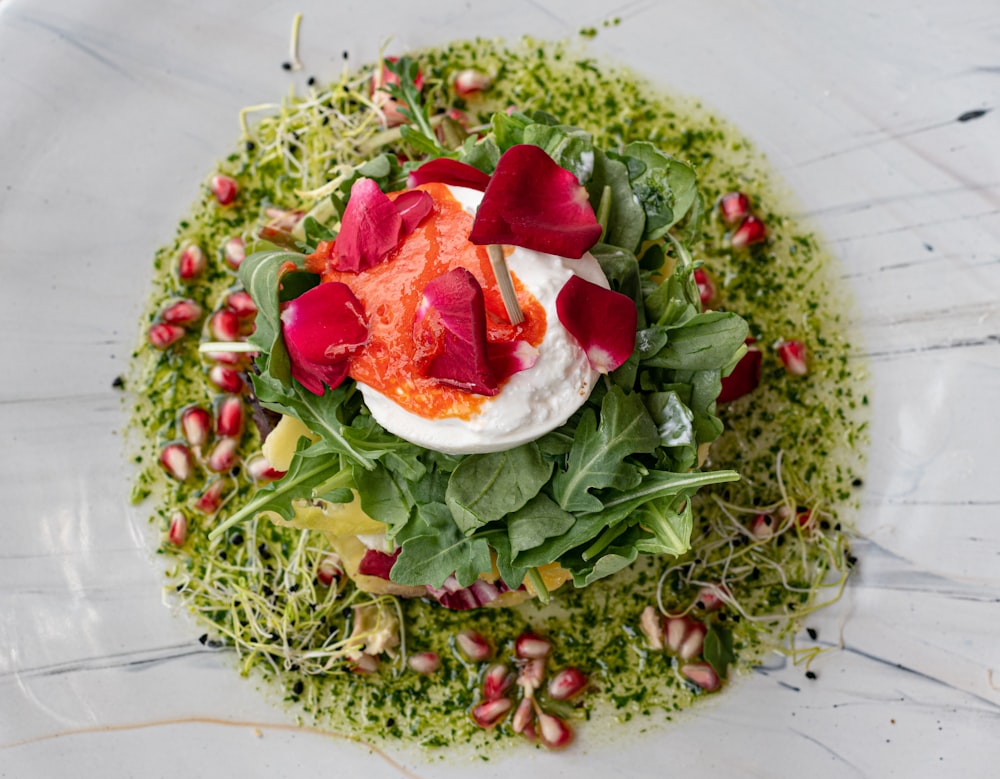 a white plate topped with a salad covered in toppings