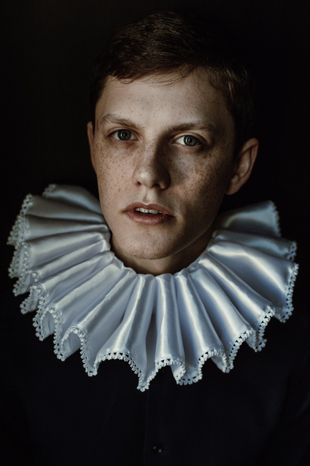 a woman with freckled collar and black shirt