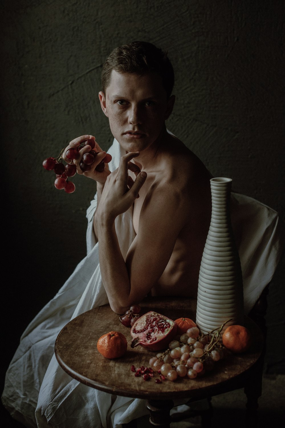 a man sitting at a table with a plate of food