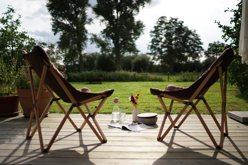 a couple of chairs sitting on top of a wooden deck