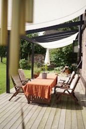 a table and chairs on a wooden deck