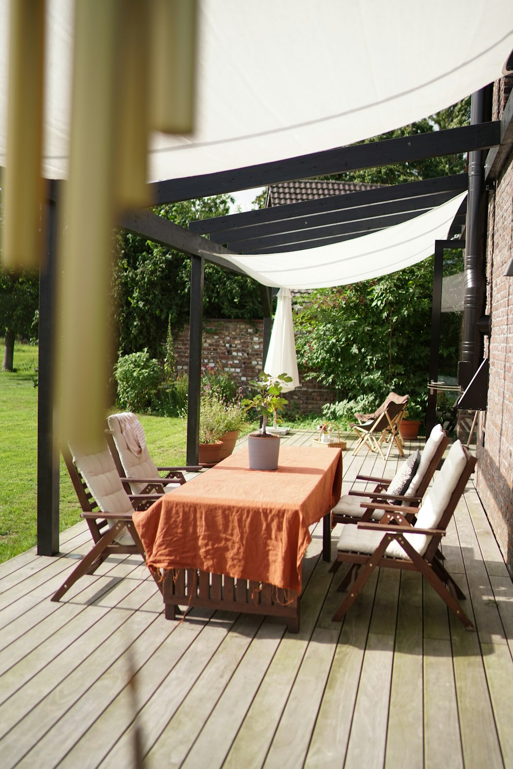 a table and chairs on a wooden deck