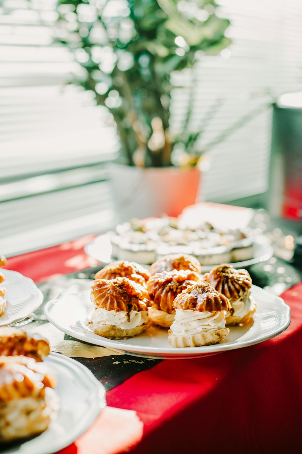 a table topped with plates of food and a potted plant