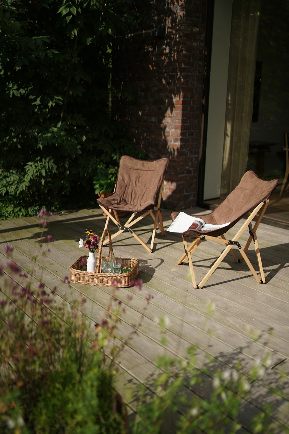 a couple of lawn chairs sitting on top of a wooden deck