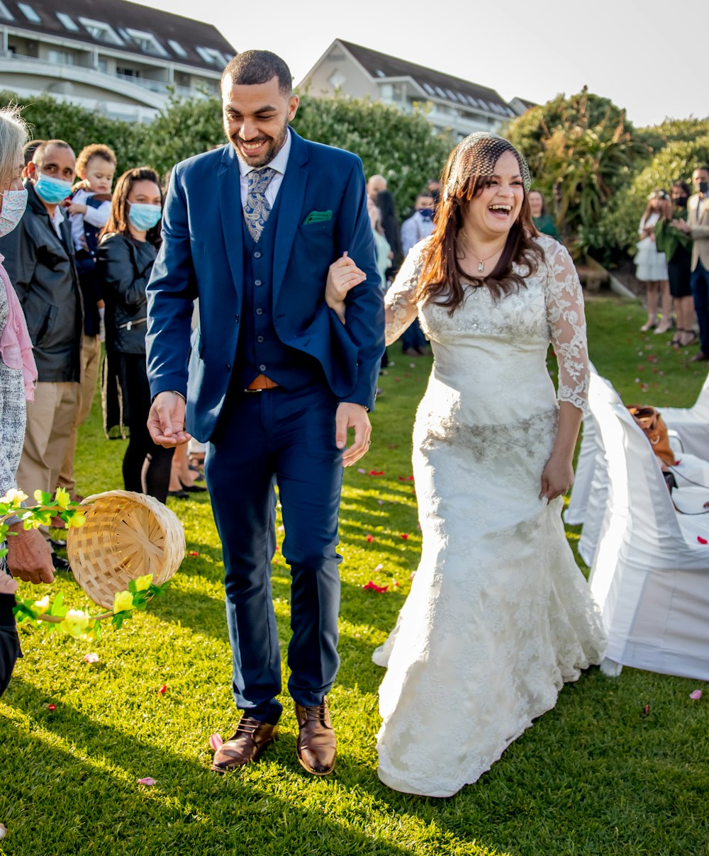 a bride and groom walking down the aisle