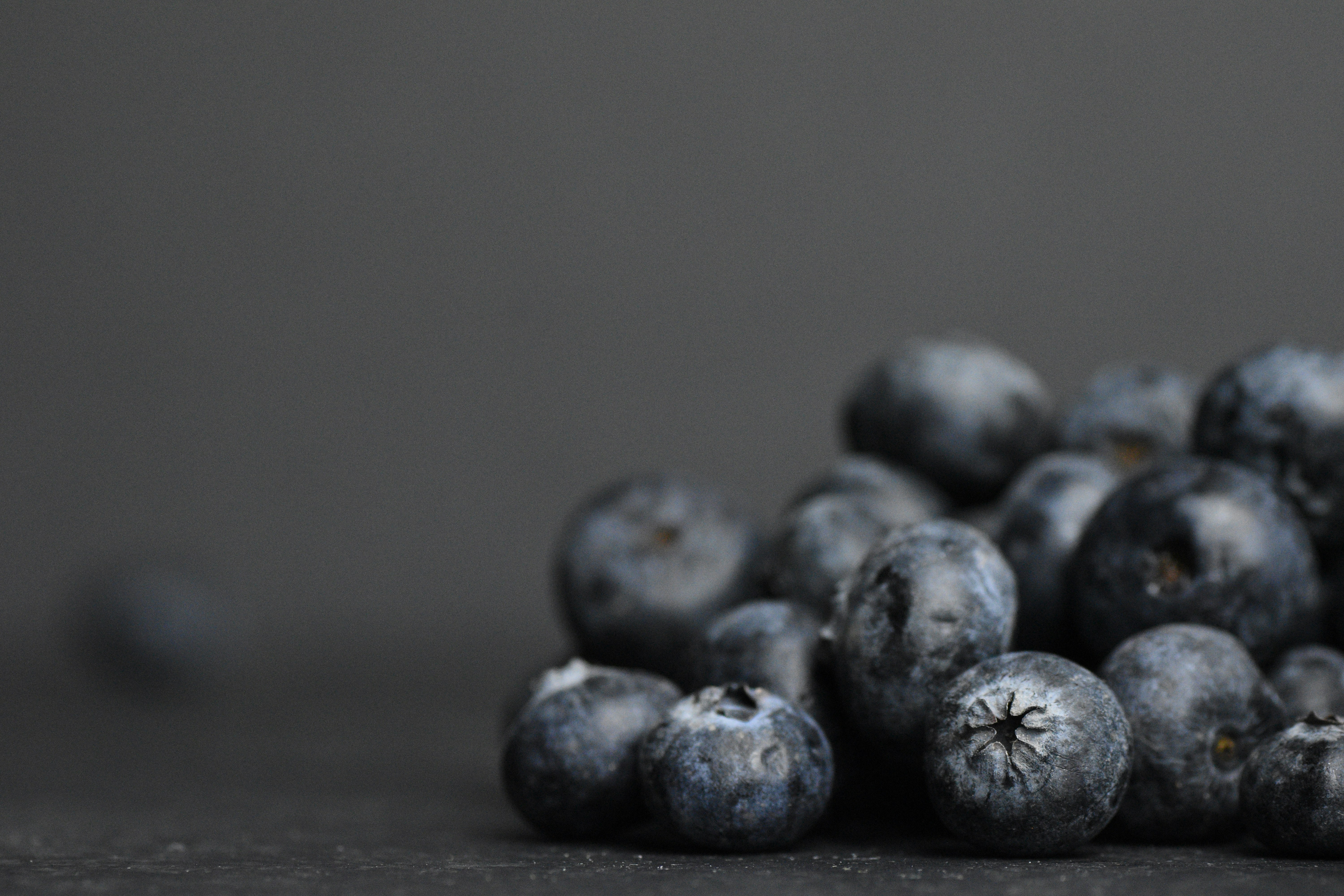 a pile of blueberries sitting on top of a table