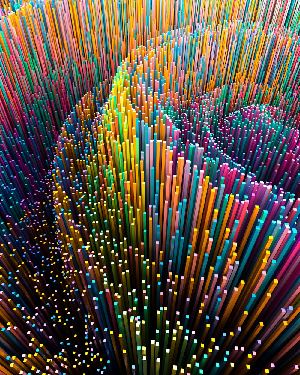 a large group of multicolored straws in a circle