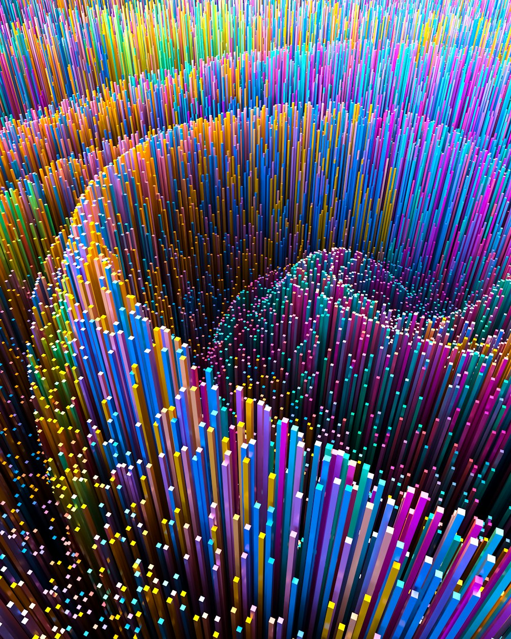 a very large group of colorful sticks in the shape of a spiral
