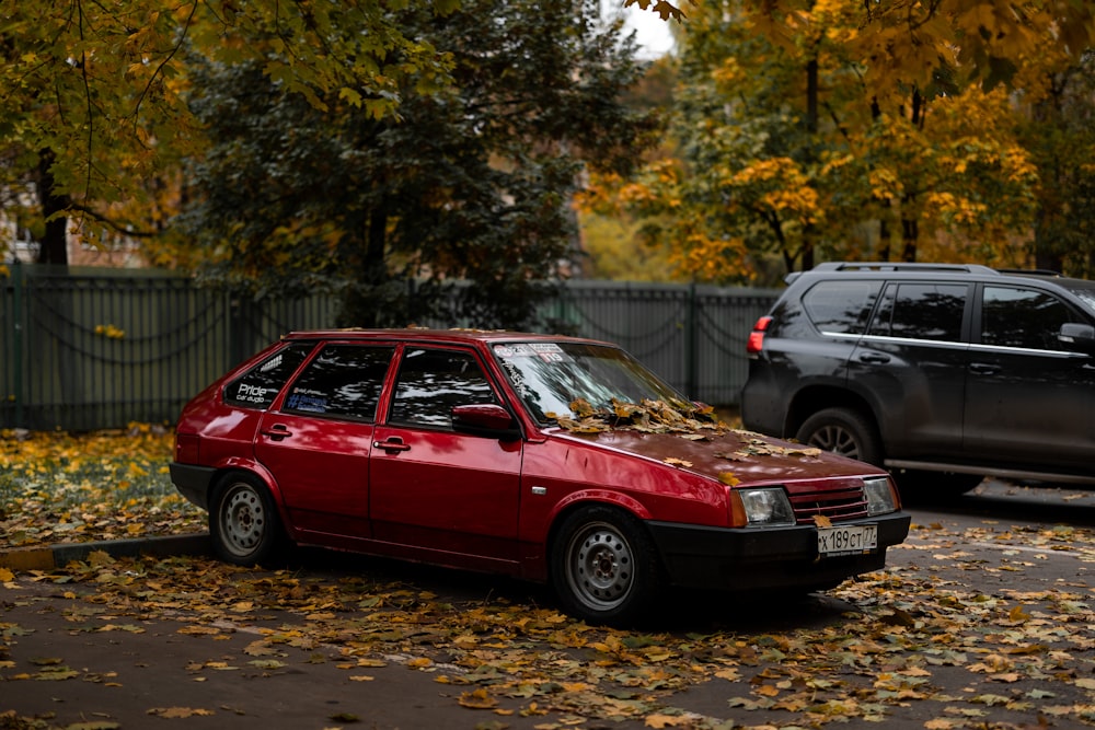 a red car parked next to a black car