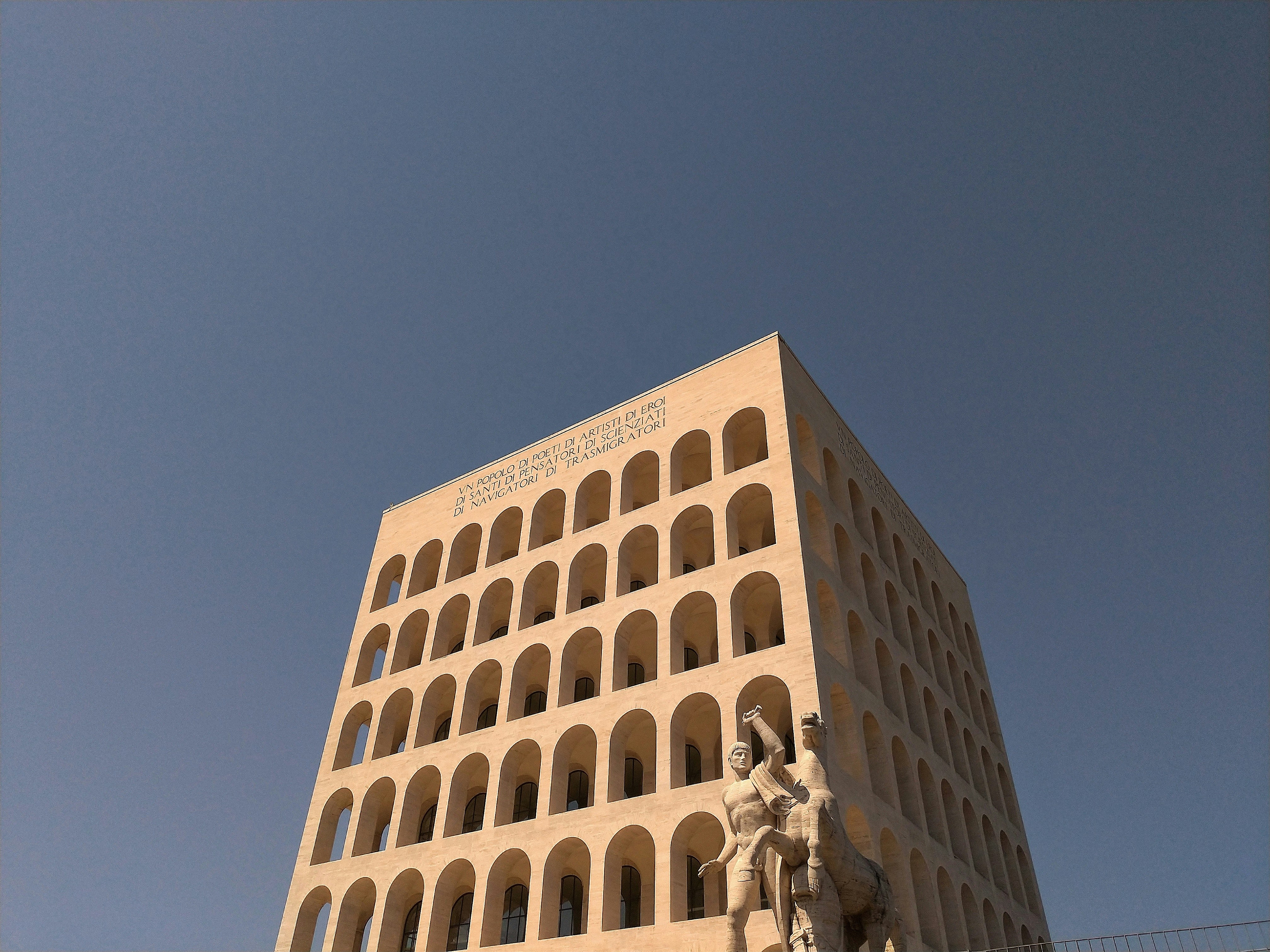 um edifício alto com uma estátua na frente dele