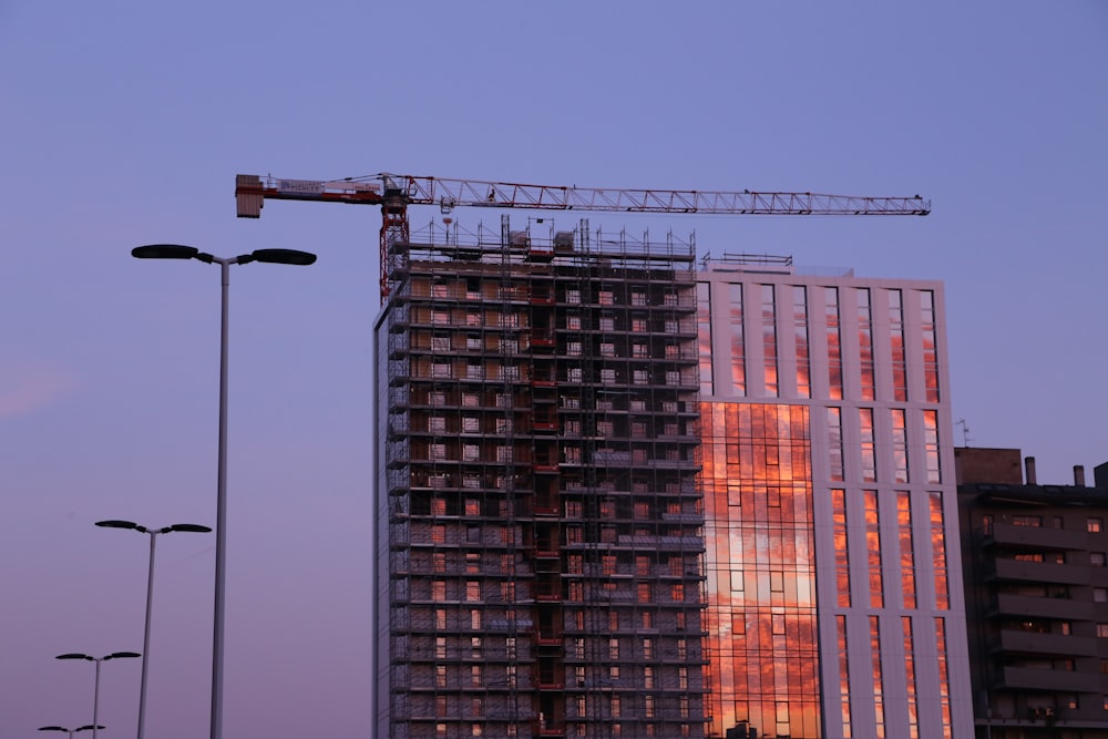 a tall building with a crane on top of it