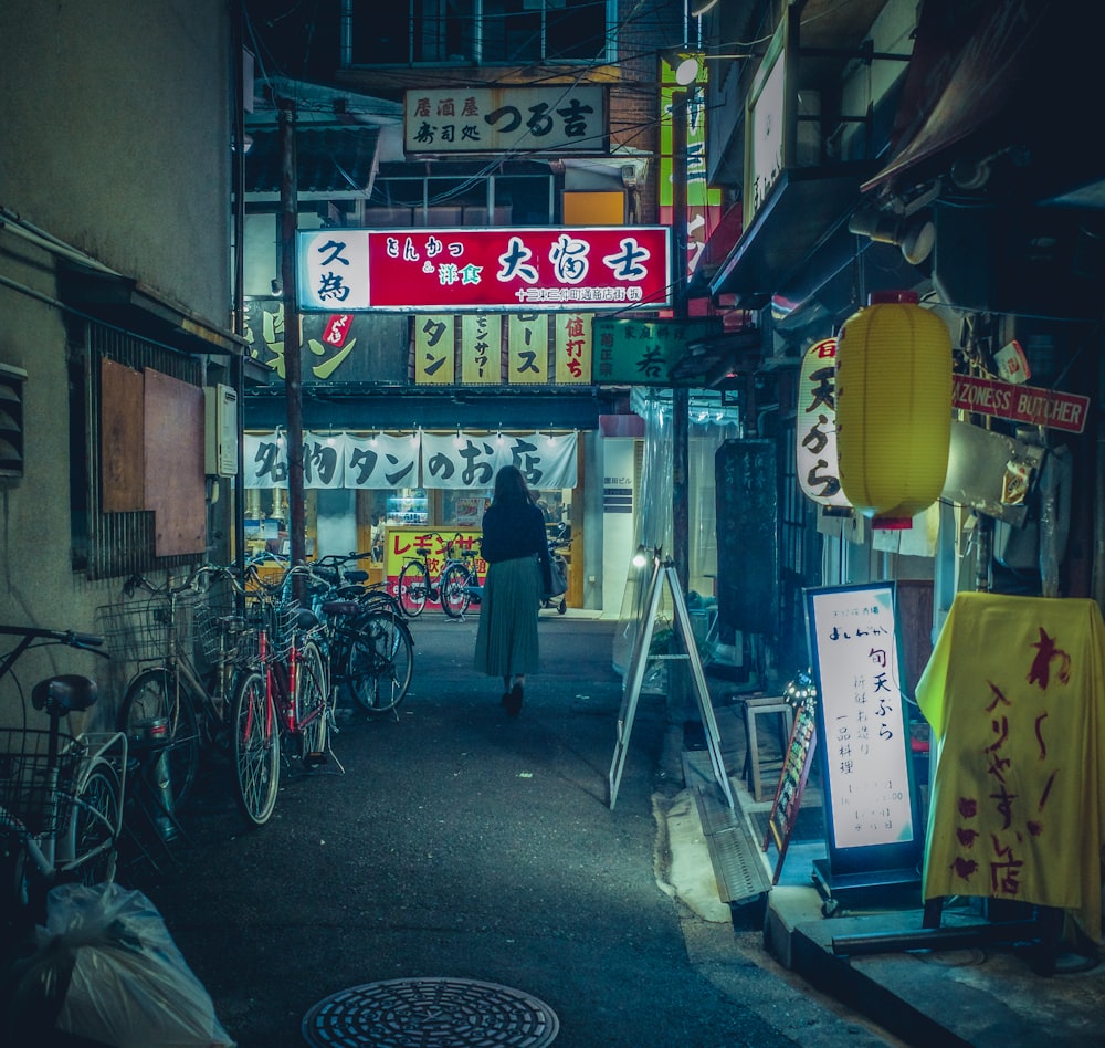 a person walking down a street in an alley