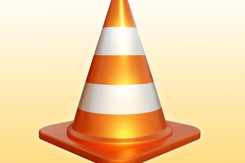 an orange and white traffic cone on a yellow background