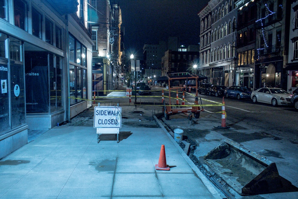 a closed down sidewalk with a sign on it