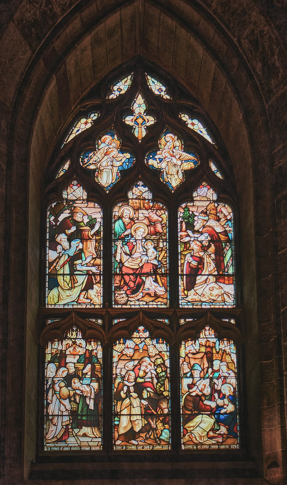a large stained glass window in a stone building