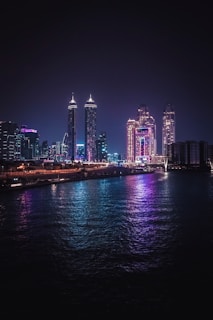 a city skyline is lit up at night