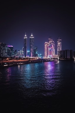a city skyline is lit up at night