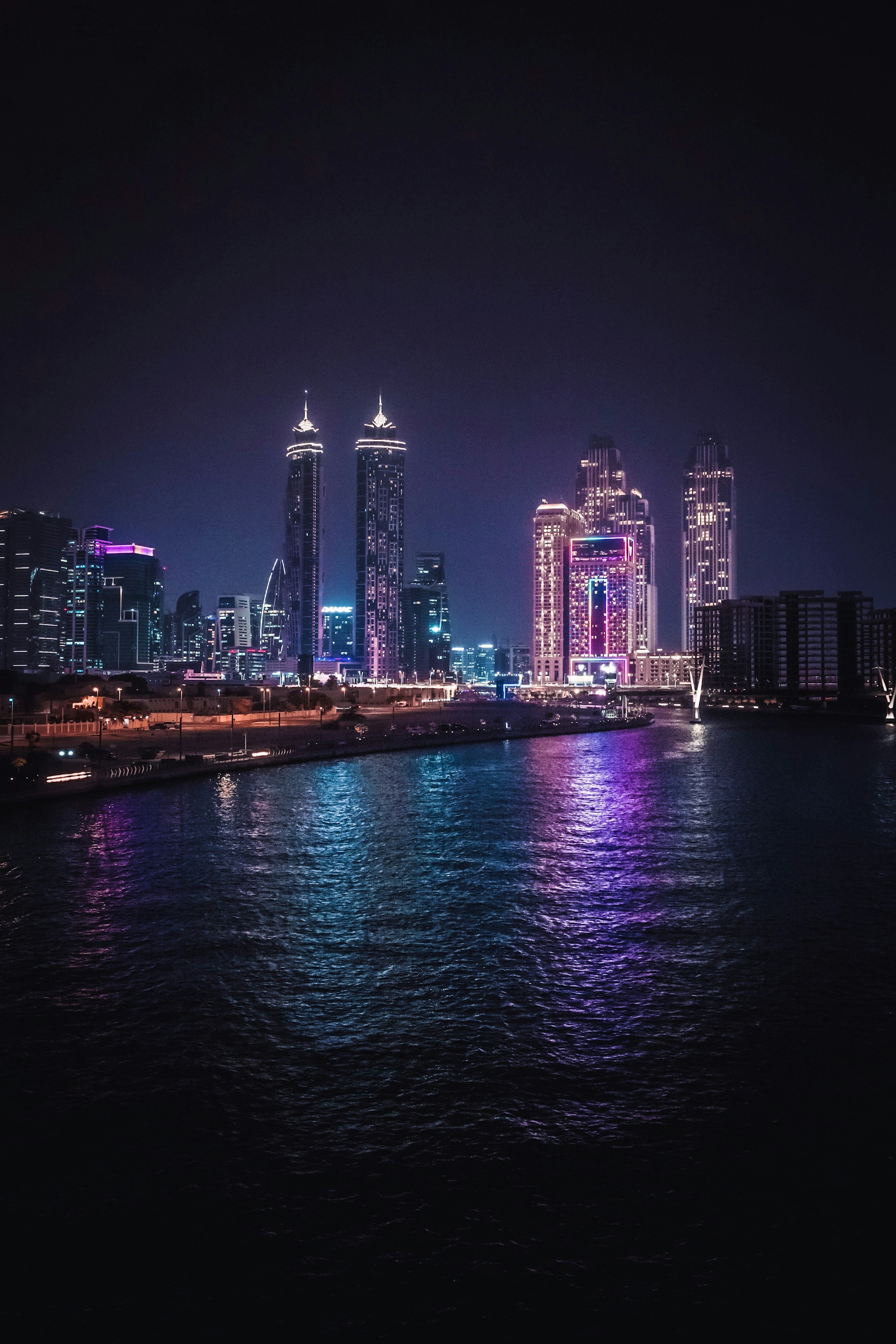 a city skyline is lit up at night