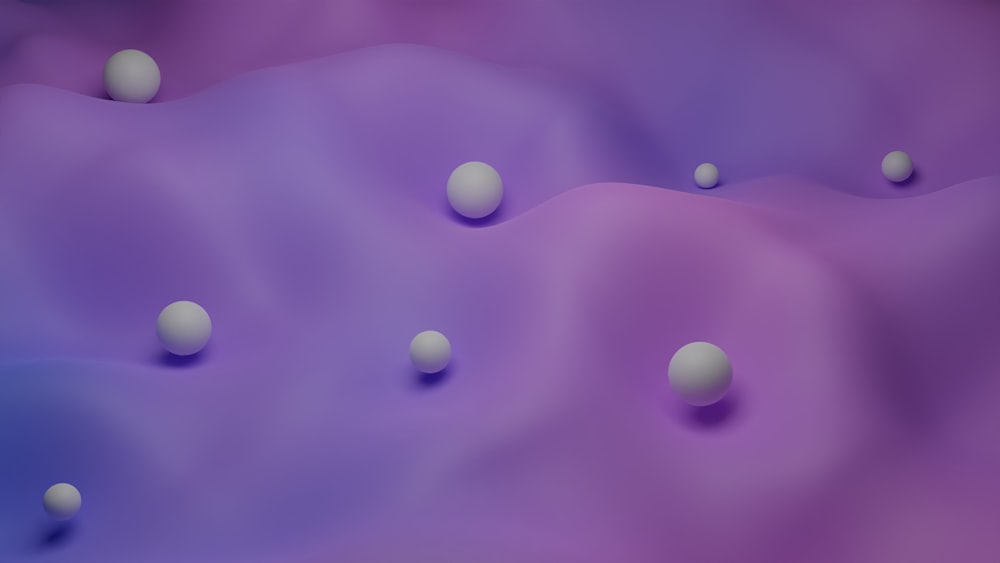 Un grupo de bolas blancas flotando sobre un fondo púrpura