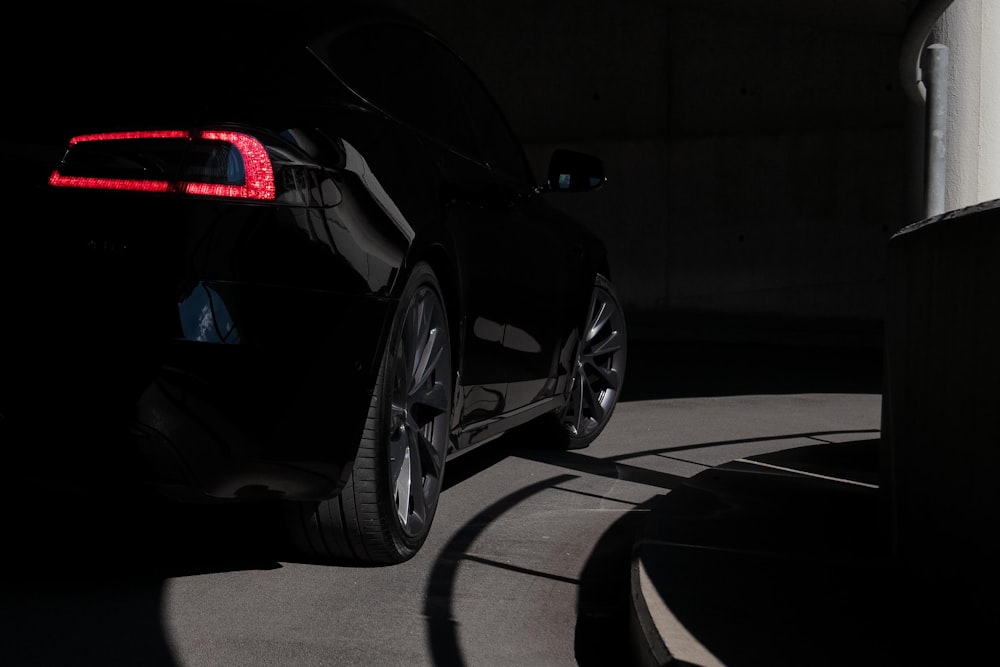 a black car parked in a parking garage