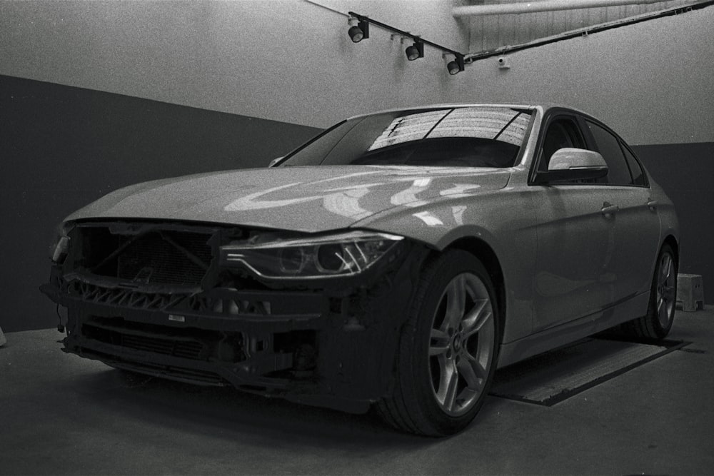 a black and white photo of a car in a garage