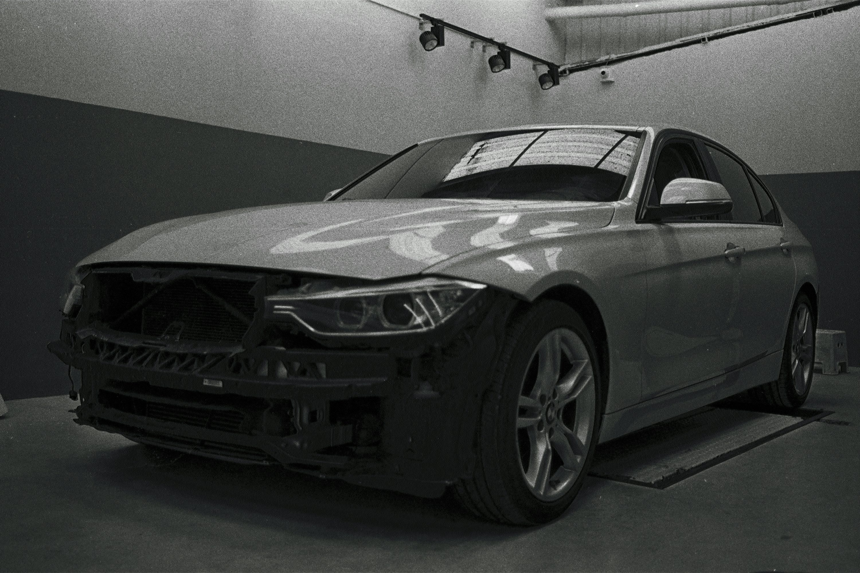a black and white photo of a car in a garage