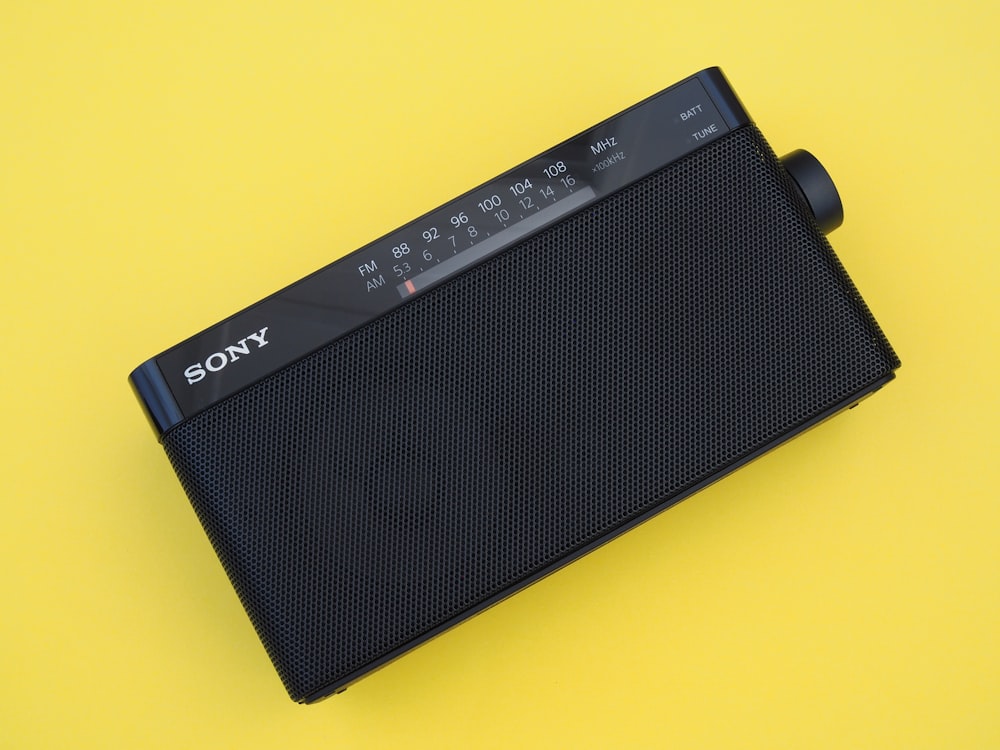 a sony radio sitting on top of a yellow surface