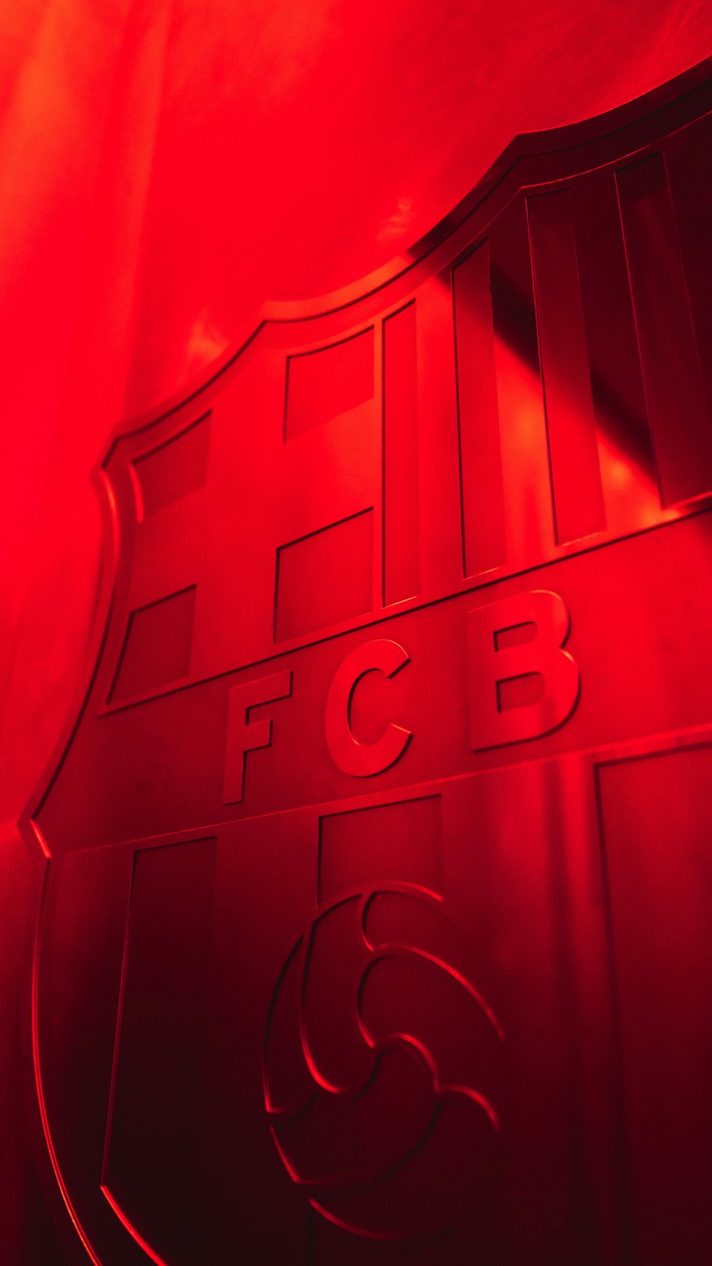 a close up of a red wall with a logo on it