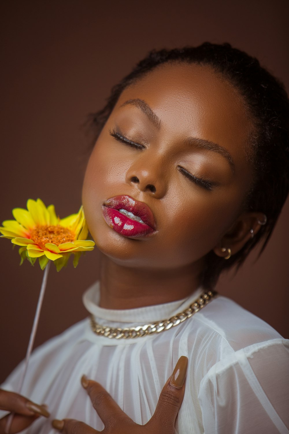 a woman with a flower in her mouth