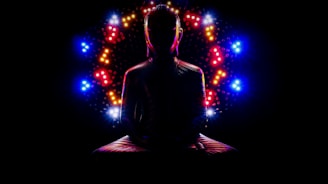 a man sitting in a lotus position with a lot of lights around him