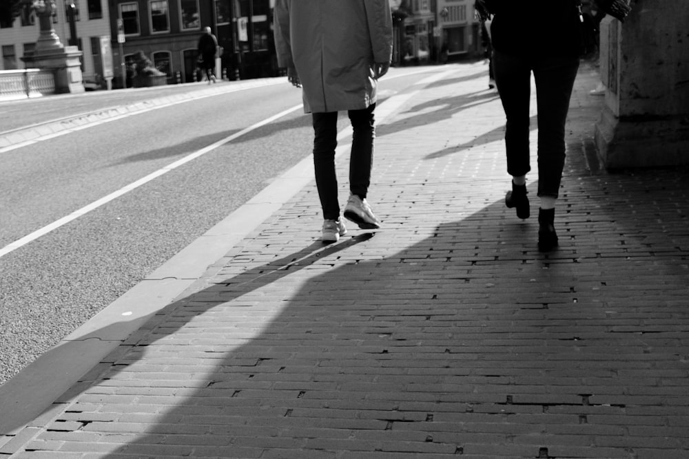 a couple of people walking down a street