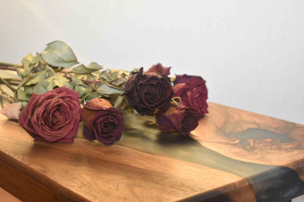 a bunch of flowers sitting on top of a wooden table