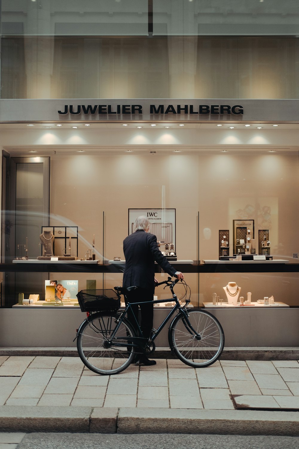 a man standing next to a bike in front of a store