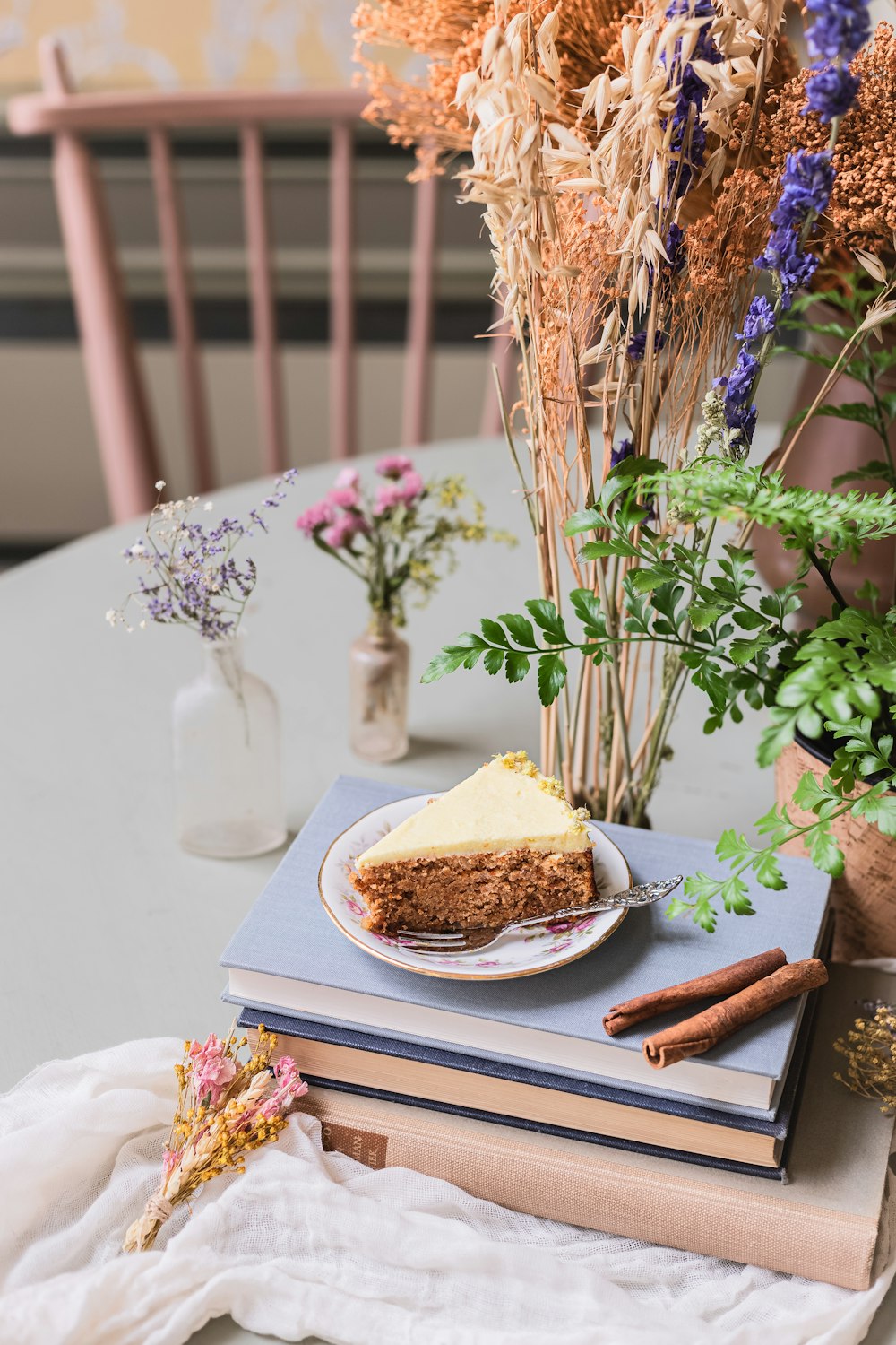 a piece of cake sitting on top of a stack of books